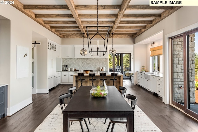 dining room featuring a barn door, beamed ceiling, and dark wood-type flooring