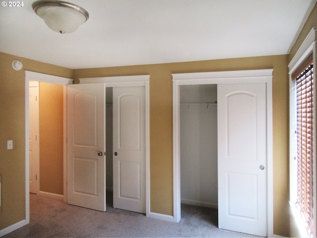 unfurnished bedroom with carpet and a closet