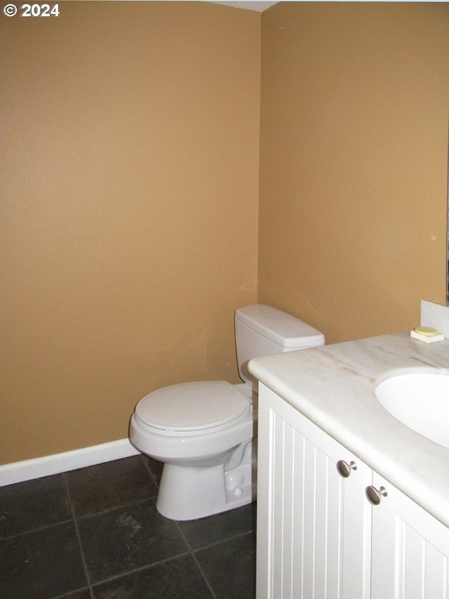 bathroom with vanity, toilet, and tile patterned floors