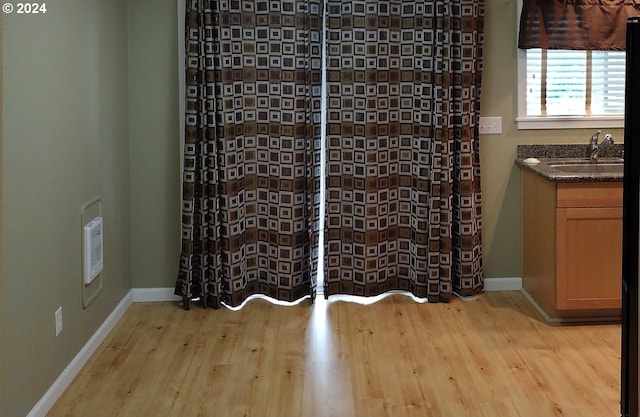 spare room featuring light hardwood / wood-style floors and sink