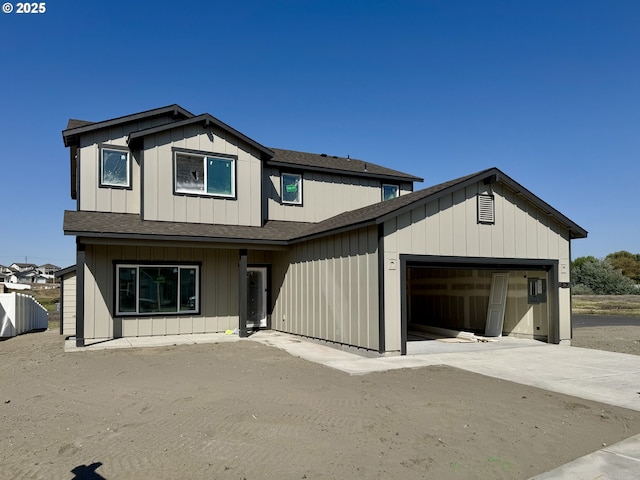 view of front of home featuring a shingled roof and a garage