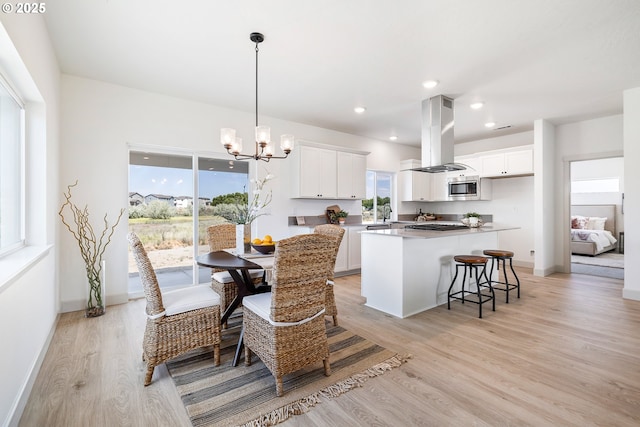 1588 NE 8th Pl, Hermiston, OR 97838 - dining space featuring light wood-type flooring, a chandelier, and recessed lighting