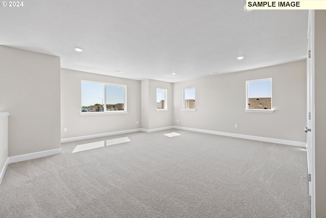 carpeted spare room with baseboards and recessed lighting