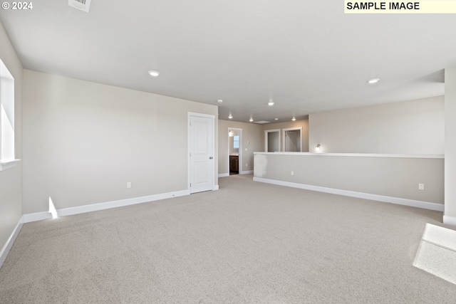interior space with baseboards, visible vents, recessed lighting, and light colored carpet