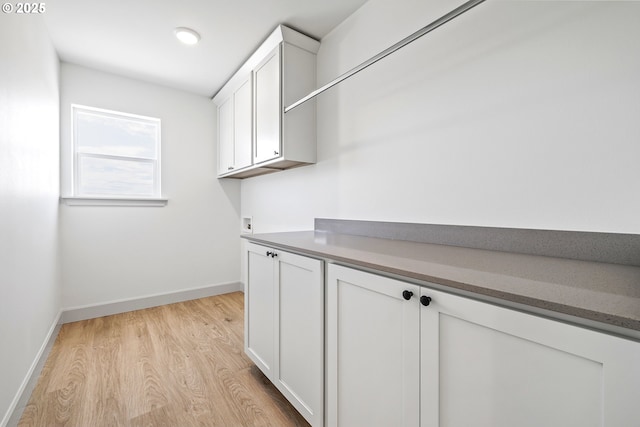 1588 NE 8th Pl, Hermiston, OR 97838 - laundry room with cabinet space, light wood-style flooring, and washer hookup