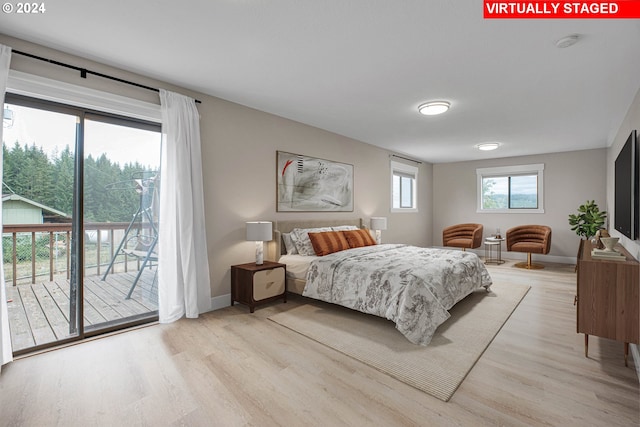 bedroom featuring light wood-type flooring and access to exterior