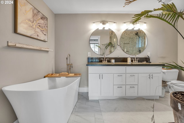 bathroom with vanity, toilet, and a washtub