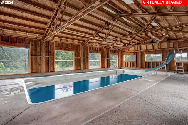 view of swimming pool with a diving board and a water slide