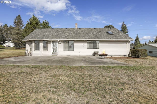 back of property featuring a patio and a yard