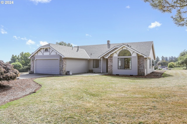 ranch-style house featuring a front yard and a garage