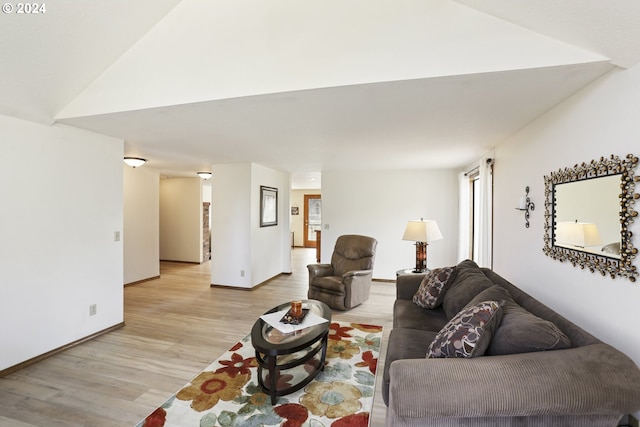 living room with light hardwood / wood-style flooring and lofted ceiling