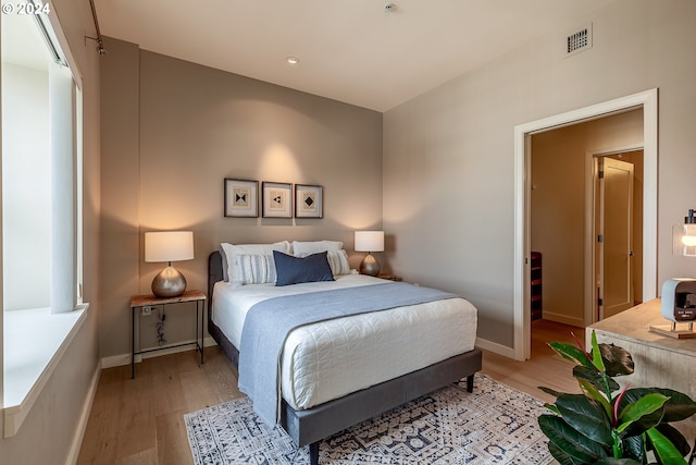 1025 NW Couch St Unit 1020, Portland, OR 97209 - bedroom with light wood-type flooring, baseboards, and recessed lighting