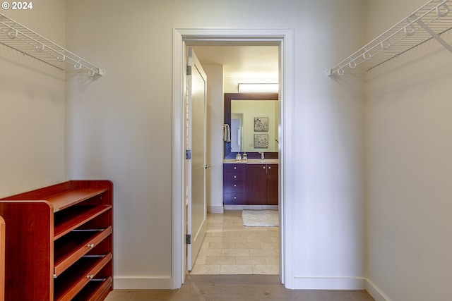 spacious closet featuring light tile patterned floors