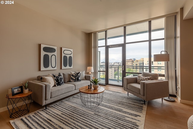 living room featuring light hardwood / wood-style flooring and a wall of windows