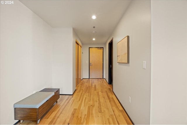 corridor with light hardwood / wood-style flooring