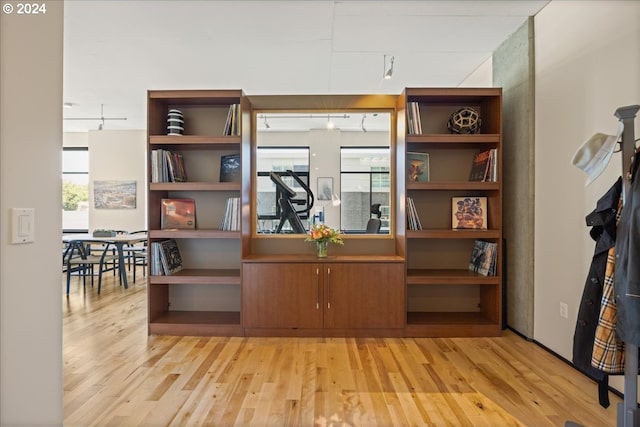 interior space featuring rail lighting and light hardwood / wood-style flooring