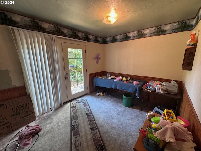 carpeted bedroom featuring access to exterior and a textured ceiling