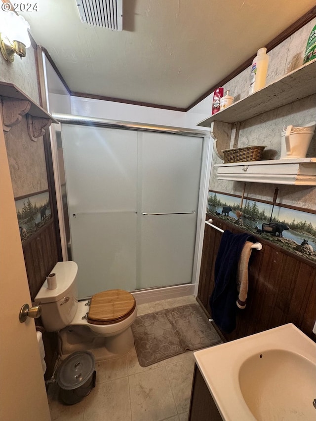 bathroom featuring toilet, tile patterned flooring, vanity, and walk in shower