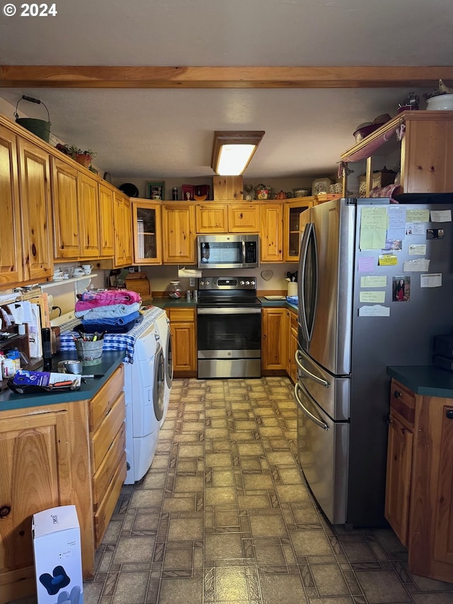 kitchen featuring separate washer and dryer and appliances with stainless steel finishes