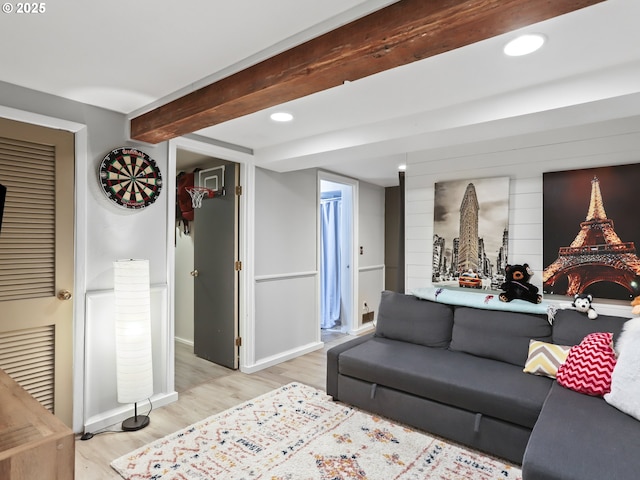 living room with beamed ceiling and light wood-type flooring