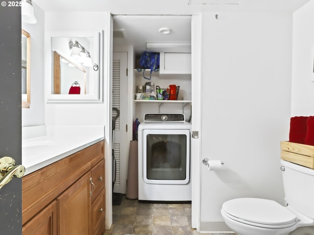 bathroom with vanity, toilet, and washer / clothes dryer