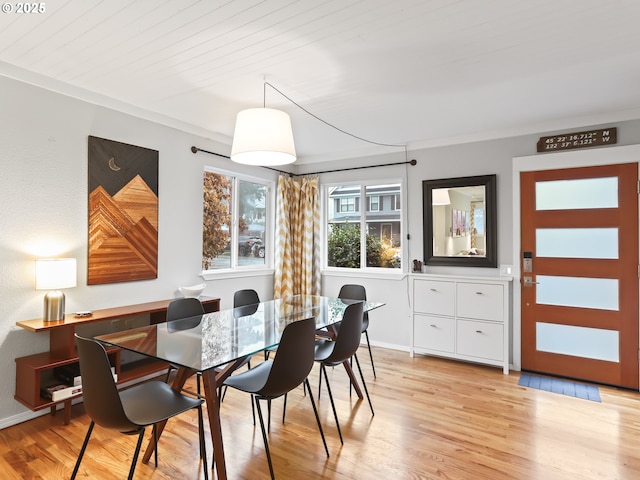 dining room with wood ceiling and light hardwood / wood-style flooring