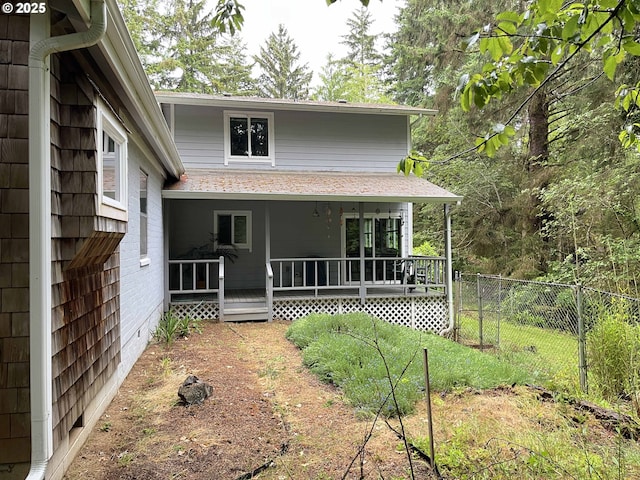 rear view of house featuring a porch