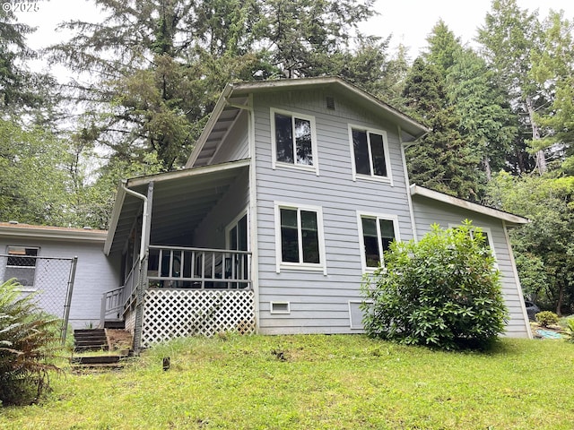 back of house with a lawn