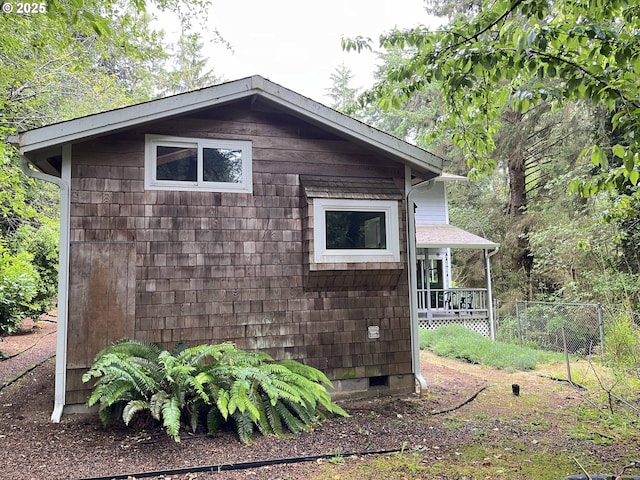 view of side of property featuring fence and crawl space