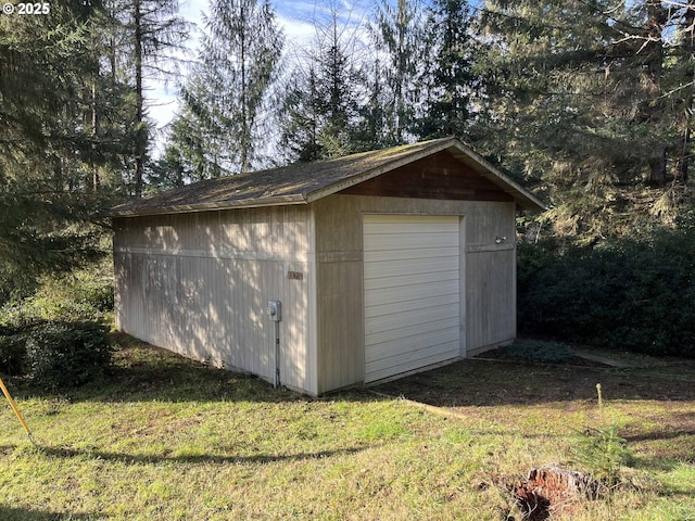 view of outbuilding with a garage and a yard