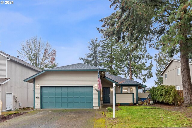 view of front facade with a front yard and a garage