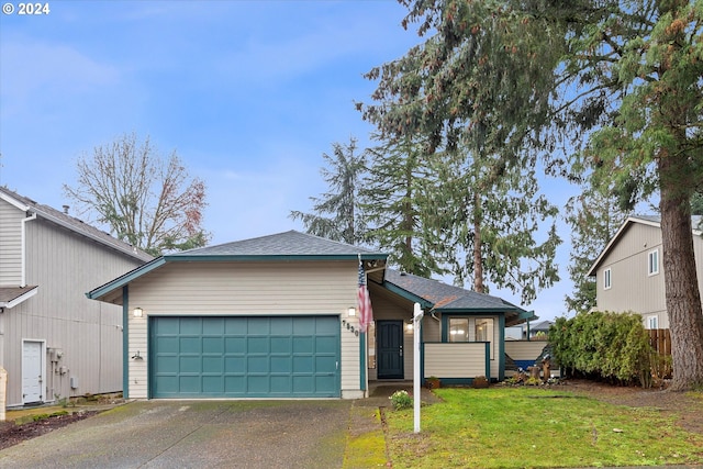 view of front of home with a garage and a front lawn