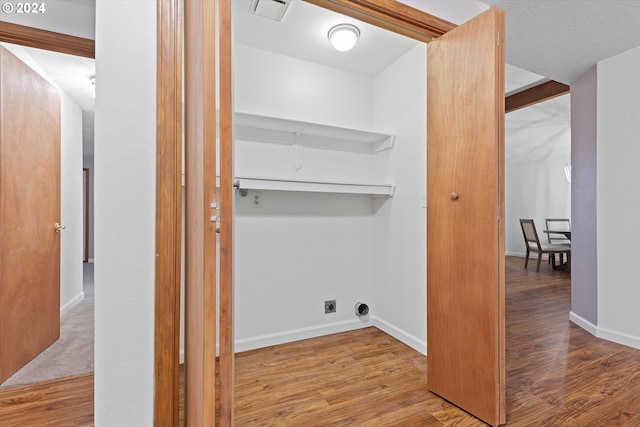 laundry area with wood-type flooring and hookup for an electric dryer