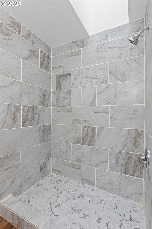 bathroom with a tile shower