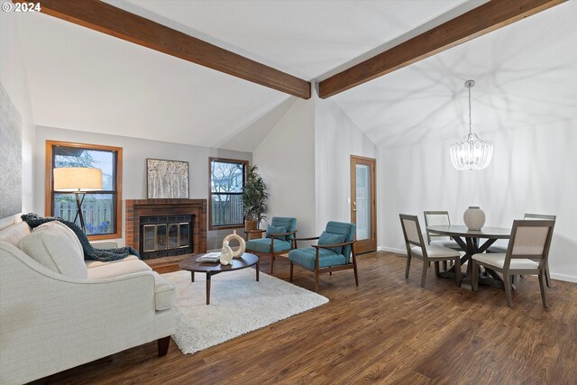 living room with beam ceiling, a brick fireplace, dark hardwood / wood-style flooring, high vaulted ceiling, and a chandelier