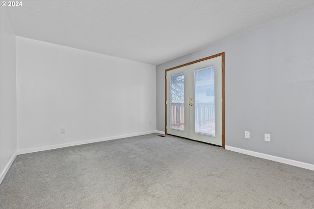 carpeted spare room with french doors