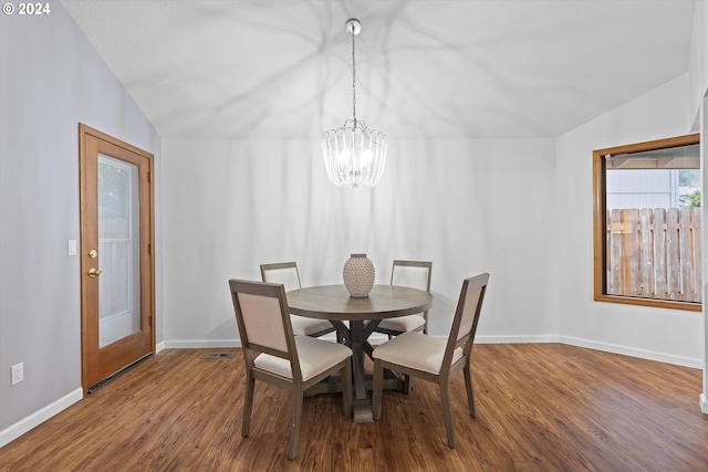 dining room with vaulted ceiling, a chandelier, and wood-type flooring