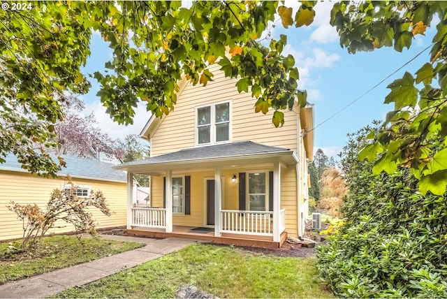 view of front of house featuring covered porch and a front lawn