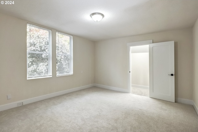 unfurnished room with light carpet