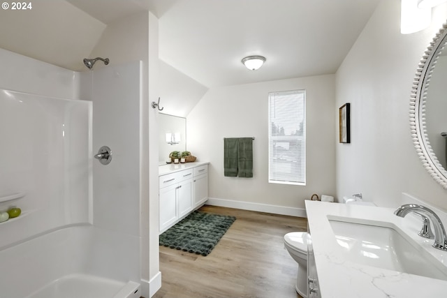full bathroom featuring lofted ceiling, wood finished floors, toilet, baseboards, and a shower