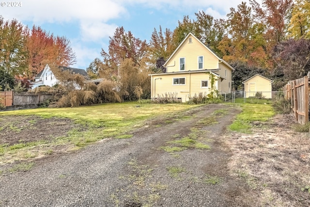 view of home's exterior featuring fence and a lawn