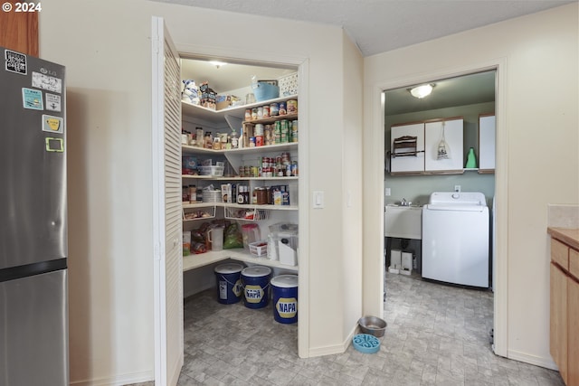 pantry featuring sink and washer / dryer