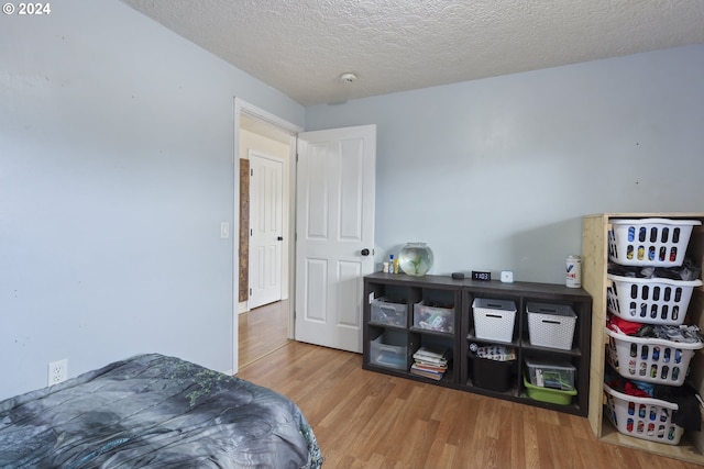 bedroom featuring wood-type flooring and a textured ceiling