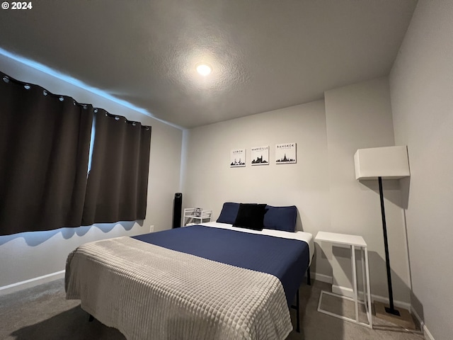 carpeted bedroom with a textured ceiling