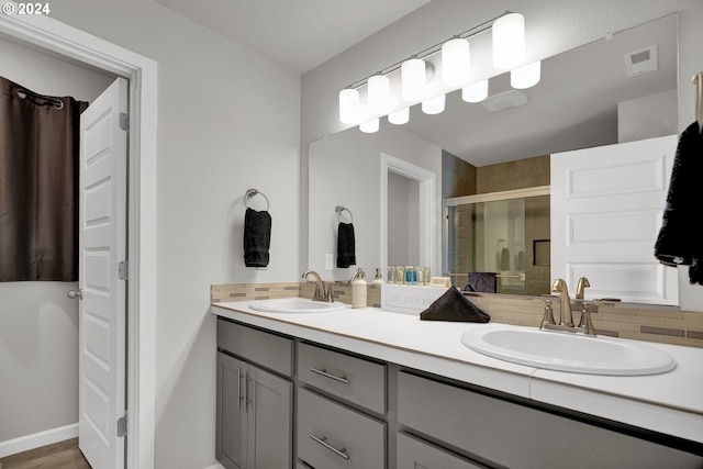 bathroom featuring walk in shower, vanity, backsplash, and hardwood / wood-style flooring