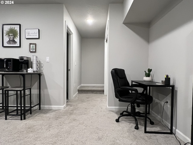 office area with light carpet and a textured ceiling