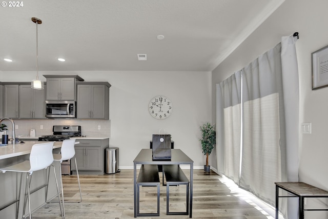 dining area featuring sink and light hardwood / wood-style floors