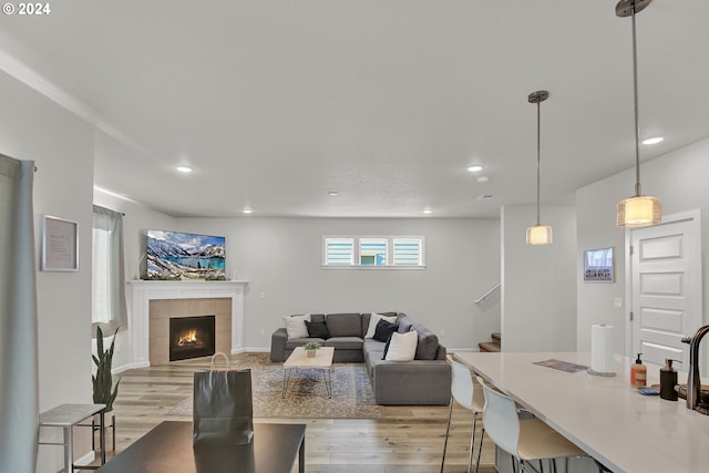 dining space with light hardwood / wood-style floors and a tile fireplace