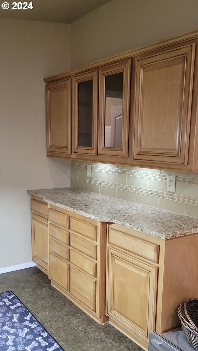 kitchen with tasteful backsplash and light stone counters