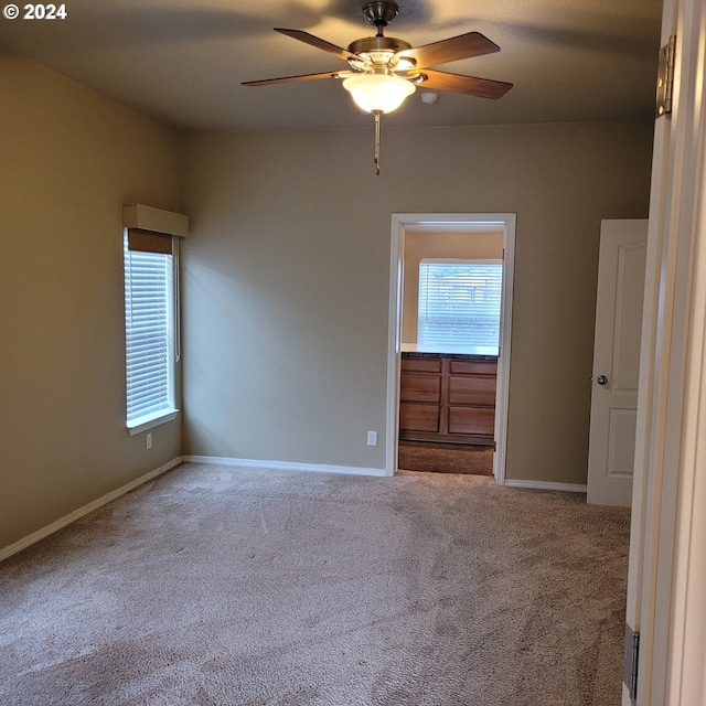 empty room featuring carpet flooring and ceiling fan